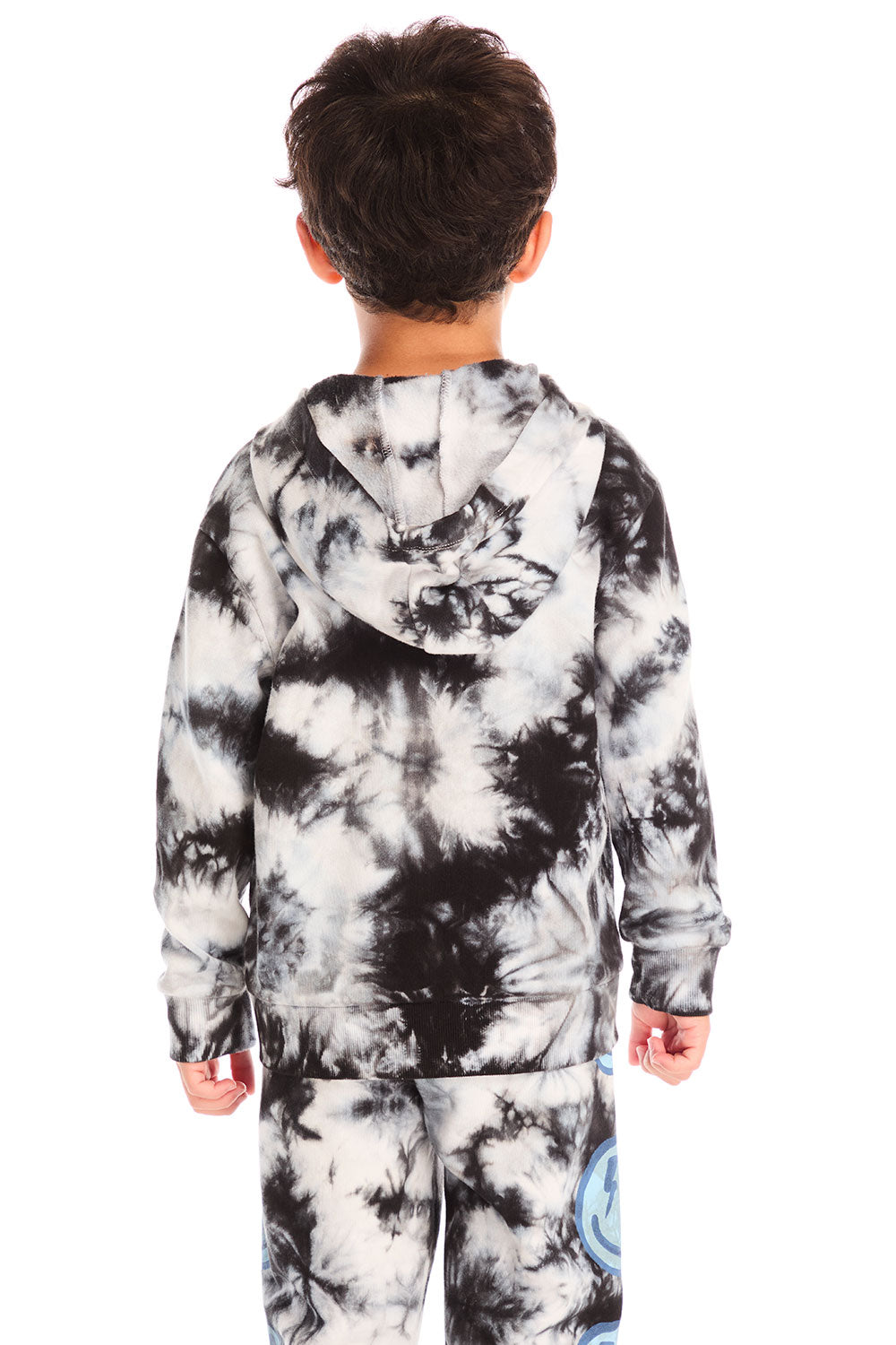 Back view of boy wearing Chaser’s Smiley Bolt tie-dye zip up hoodie on a white background