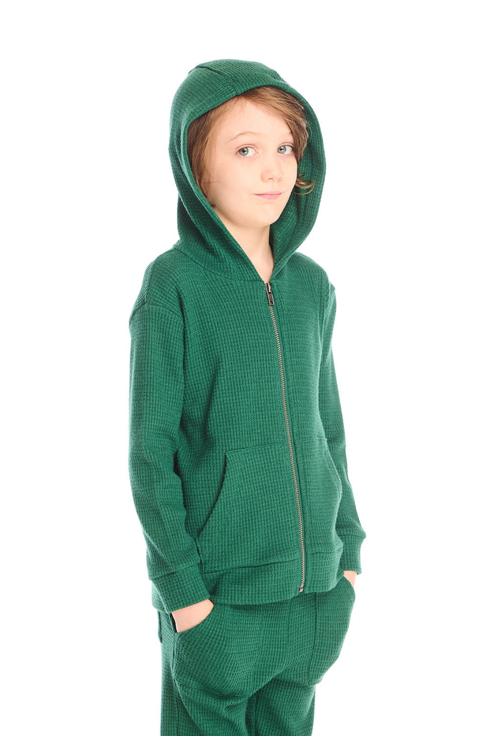 Side view of boy wearing Chaser’s Everest Green Zip Up Hoodie with hood up on a white background