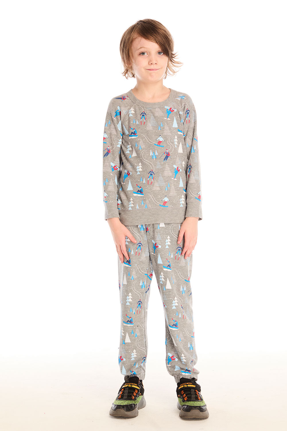 Full view of boy wearing Chaser's gray Allover Ski Slope long sleeve and matching pant with colorful patterns on a white background