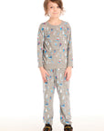 Full view of boy wearing Chaser's gray Allover Ski Slope Pants and matching top with colorful patterns on a white background