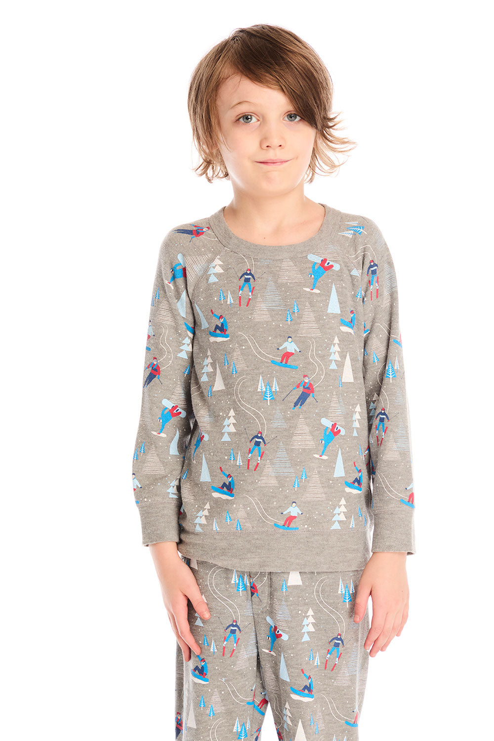 Boy wearing Chaser's gray Allover Ski Slope long sleeve and matching pant with colorful patterns on a white background