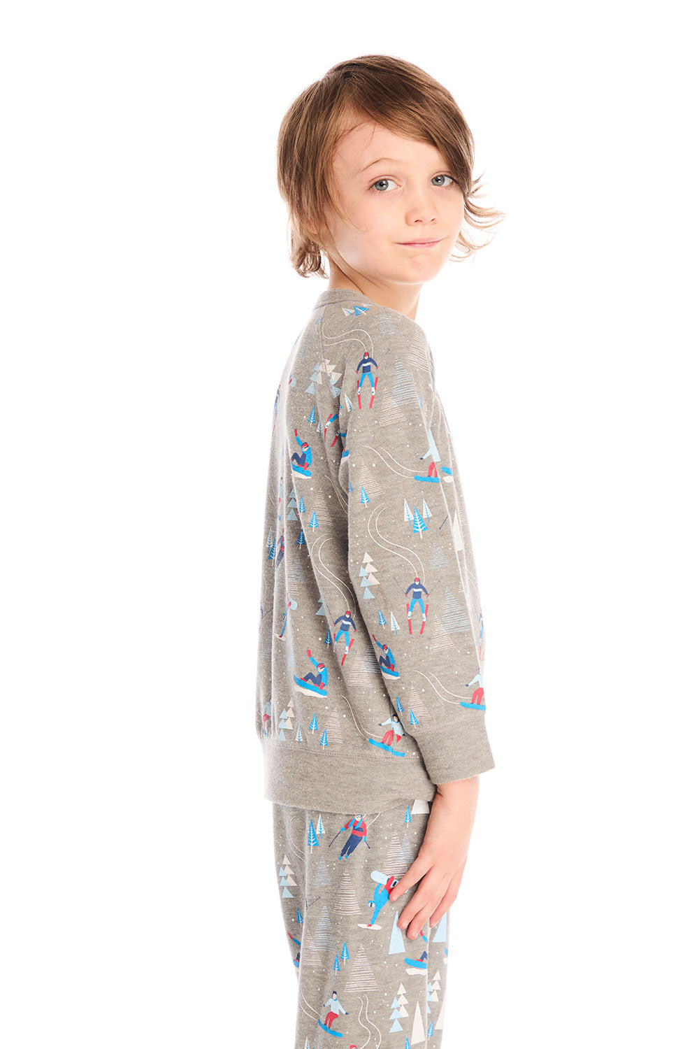 Side view of boy wearing Chaser's gray Allover Ski Slope long sleeve and matching pant with colorful patterns on a white background
