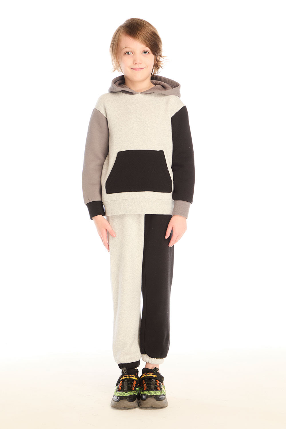 Full body front view of boy wearing Chaser’s Colorblocked Lounge Pant with matching color-blocked long sleeve hoodie on a white background