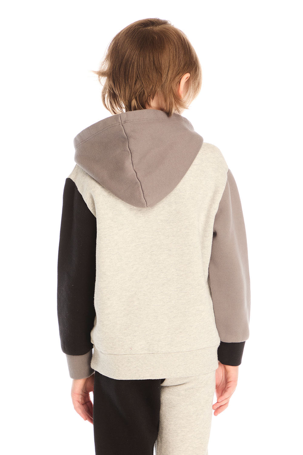 Back view of boy wearing Chaser’s color-blocked long sleeve hoodie with matching pants on a white background