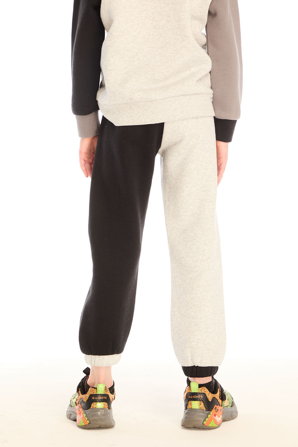 Back view of boy wearing Chaser’s Colorblocked Lounge Pant with color-blocked panels on a white background