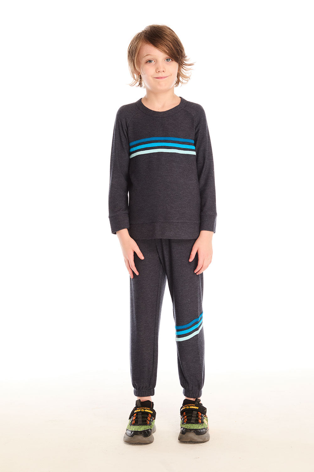 Full body view of boy wearing Chaser’s Raglan Avalon Blue Pullover top with strappings and blue stripes across the chest with matching pants on a white background