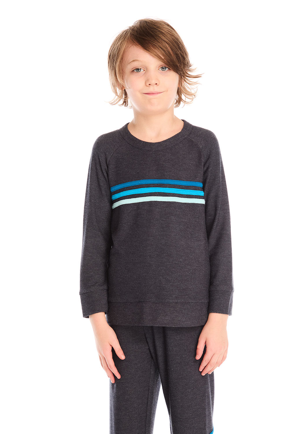 Boy wearing Chaser’s Raglan Avalon Blue Pullover top with strappings and blue stripes across the chest on a white background