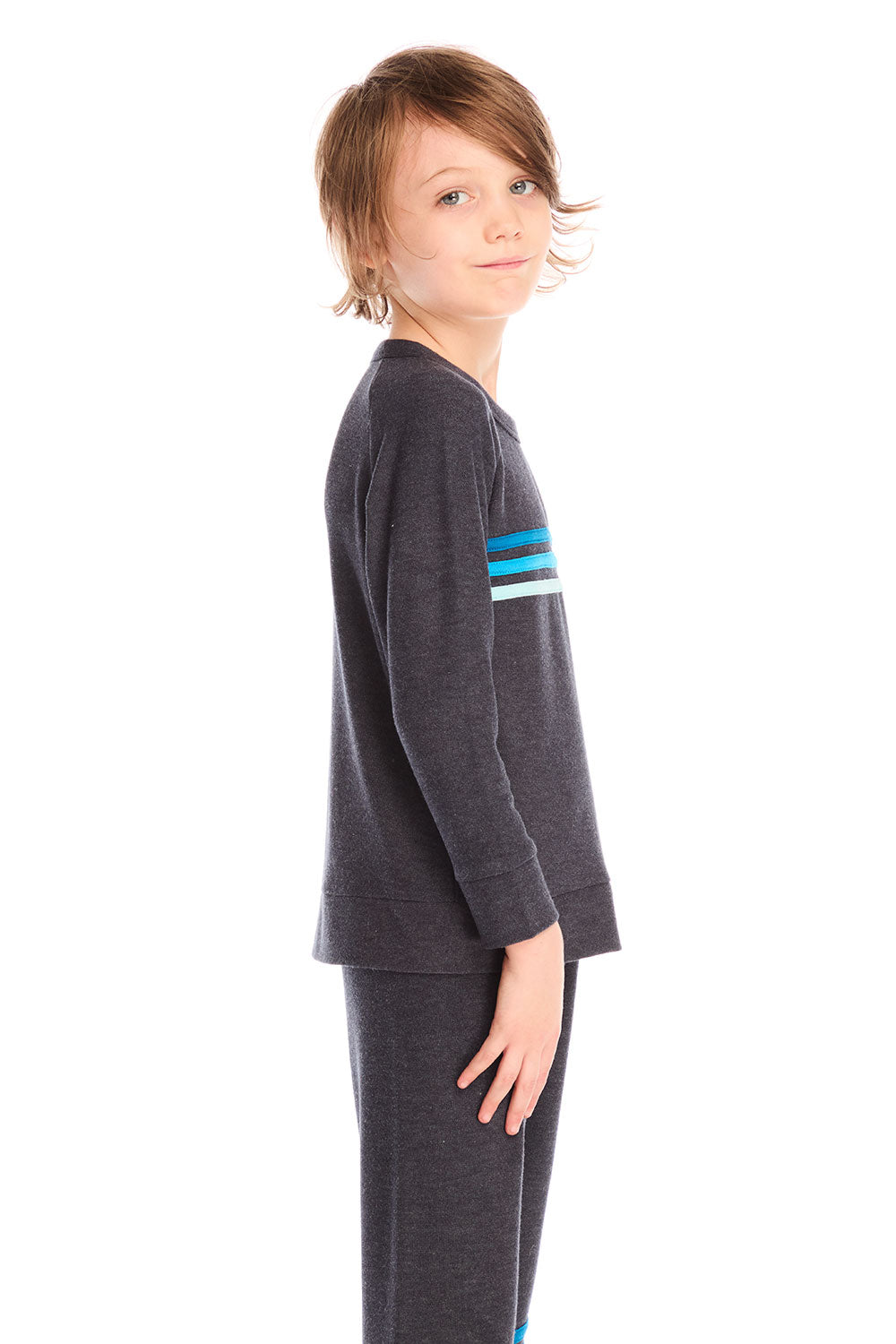 Side view of boy wearing Chaser’s Raglan Avalon Blue Pullover top with strappings and blue stripes across the chest on a white background