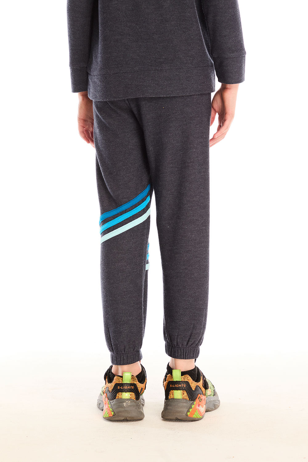 Back view of boy wearing Chaser’s Avalon Lounge Pant with blue stripe strappings against a white background