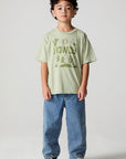 Full body front view of a boy wearing the Chaser Western Time Tee on a neutral background