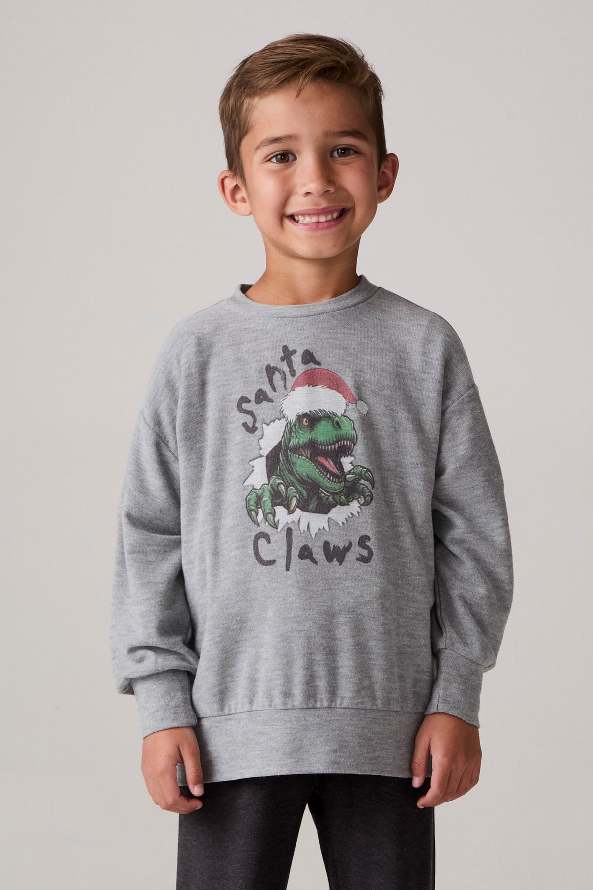 Model wearing Chaser's Santa Claws Boys Pullover in heather grey with Santa-hat dinosaur graphic, front view