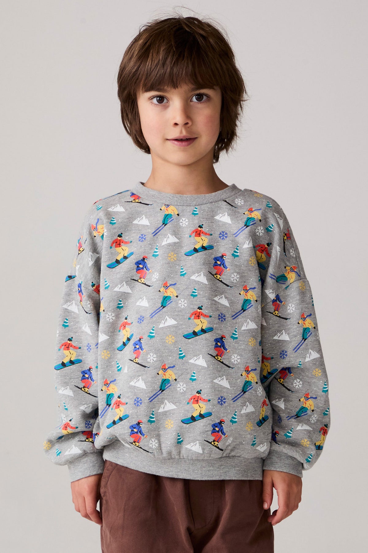 Model wearing Chaser's Dolomiti Boys Pullover in heather grey with distinctive graphic and design details, front view