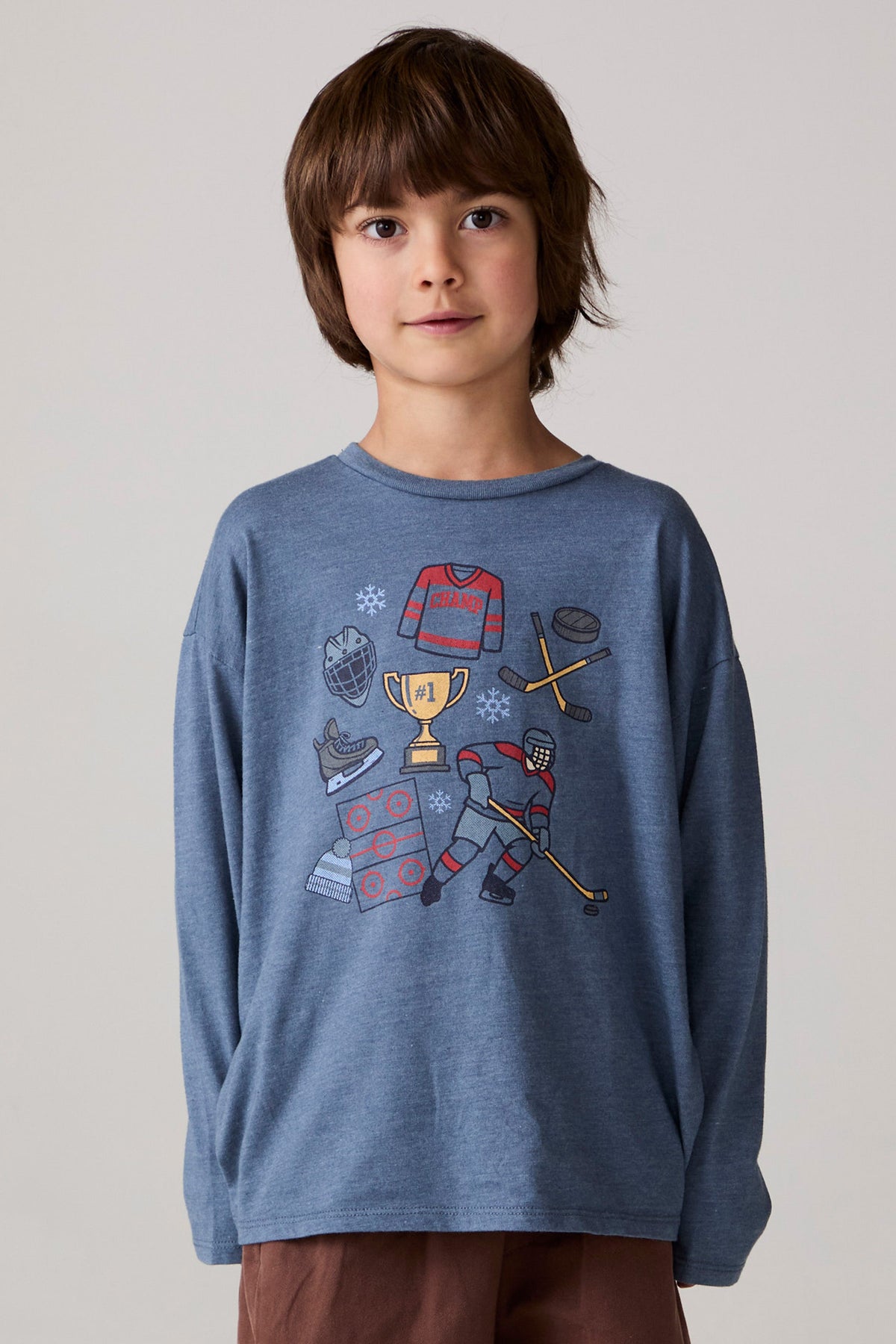 Model wearing Chaser's Champions Boys Long Sleeve Tee in blueberry jam with distinctive graphic and design details, front view
