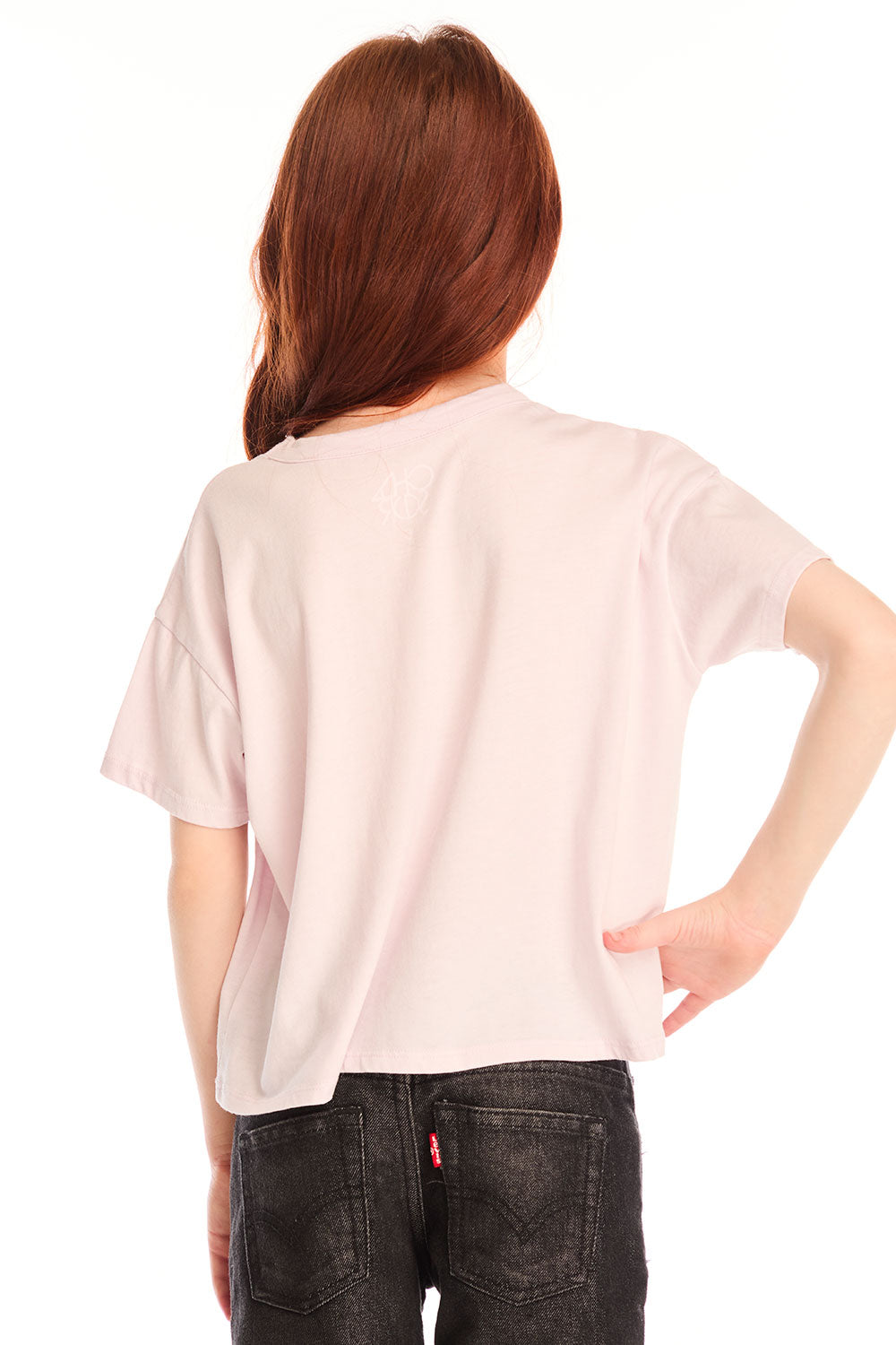 Back view of girl wearing Chaser’s light pink Love Tee in light pink on a white background