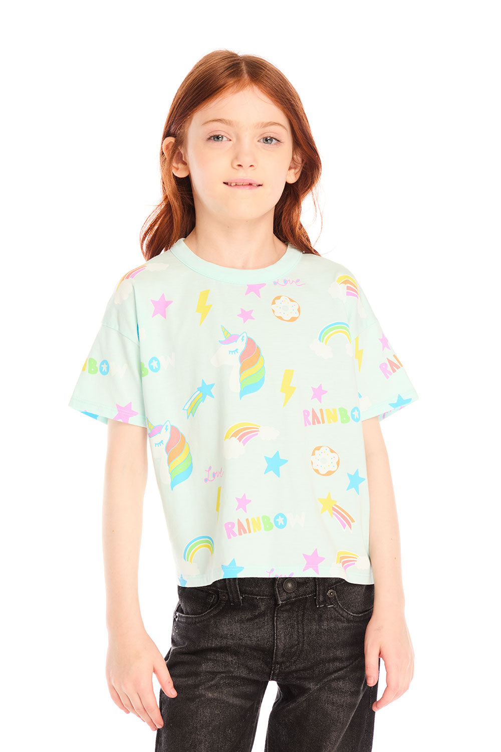 Girl wearing Chaser’s light green Unicorn Hearts Tee with text and colorful graphics against a white background