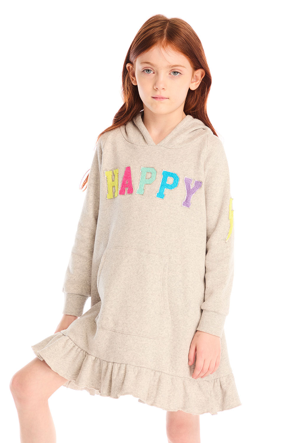 Girl wearing Chaser’s Glitter Smiley Heather Grey Hoodie Dress with long sleeves and colorful letters spelling “HAPPY” on the front against a white background