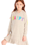 Girl wearing Chaser’s Glitter Smiley Heather Grey Hoodie Dress with long sleeves and colorful letters spelling “HAPPY” on the front against a white background