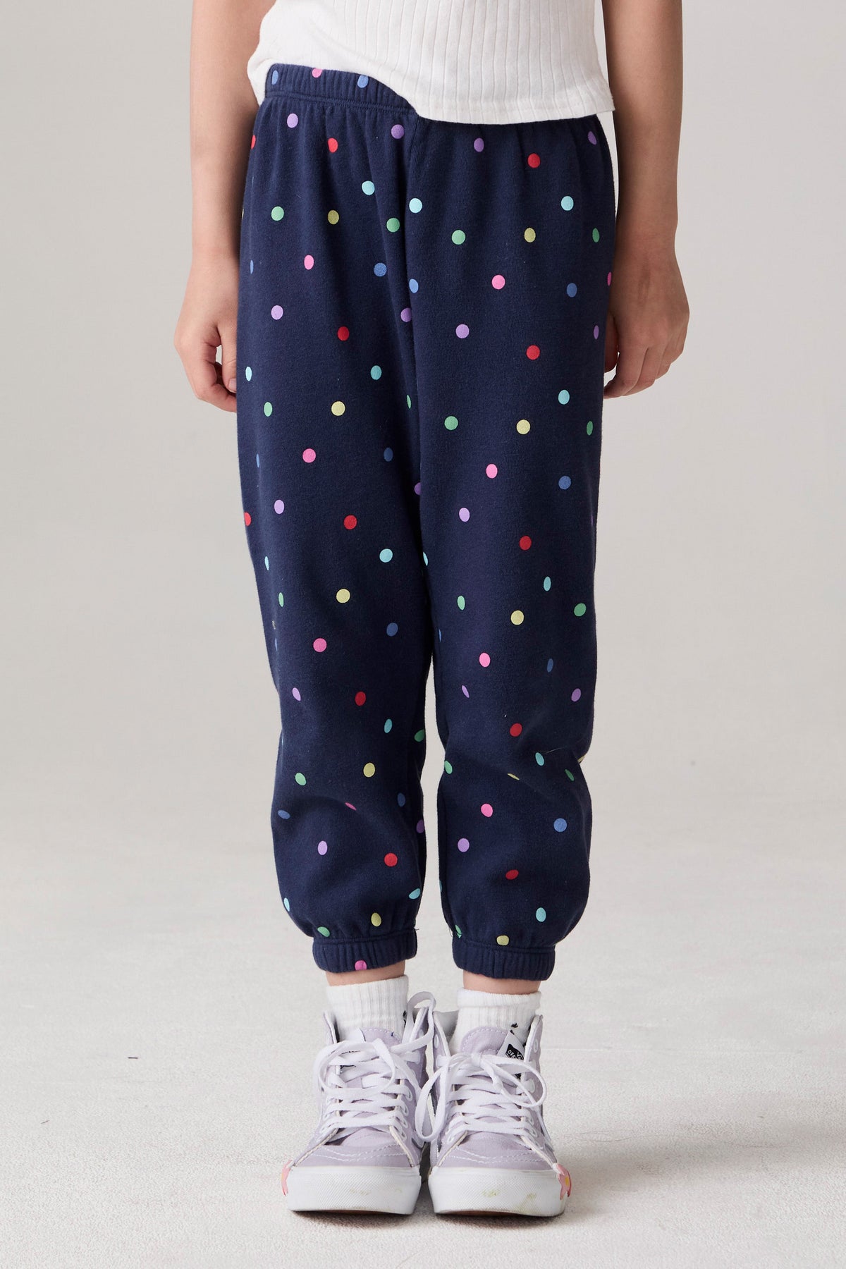 Model wearing Chaser's Festive Lights Girls Pants in Avalon with distinctive graphic and design details, front view