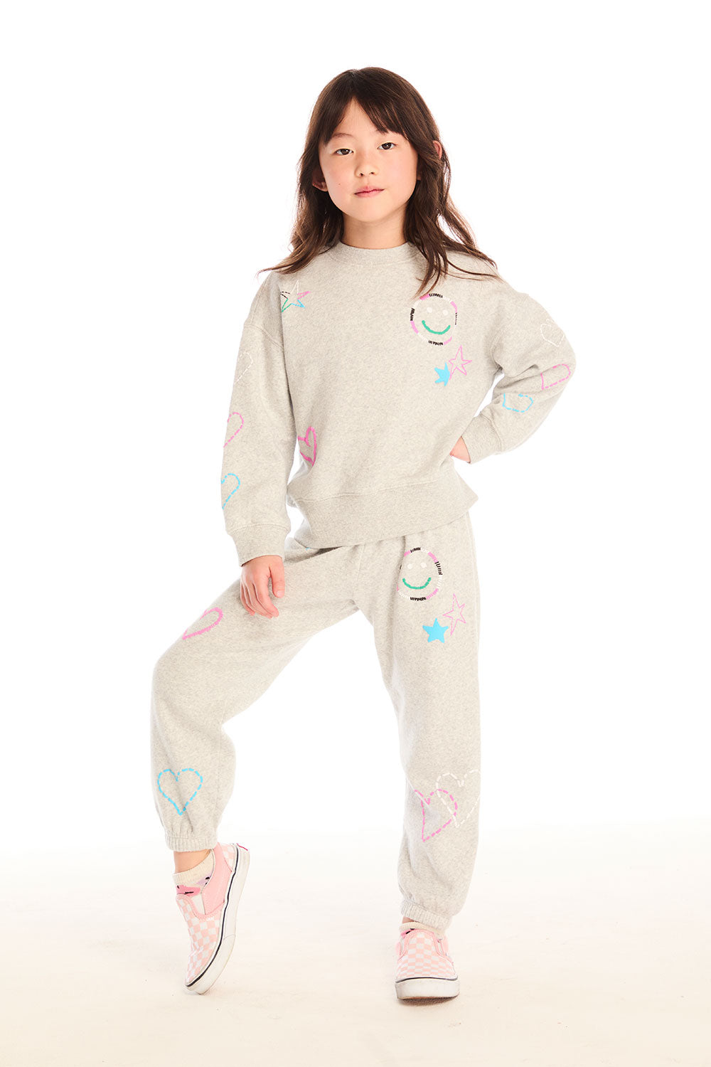 Full body view of girl wearing Chaser’s light gray Winter Love Stitches Long Sleeve with matching Winter Love Pants with colorful designs on a white background