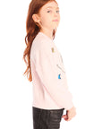 Side view of young girl wearing Chaser’s pink Be Happy Icons long sleeve pullover with smiley face design on a white background