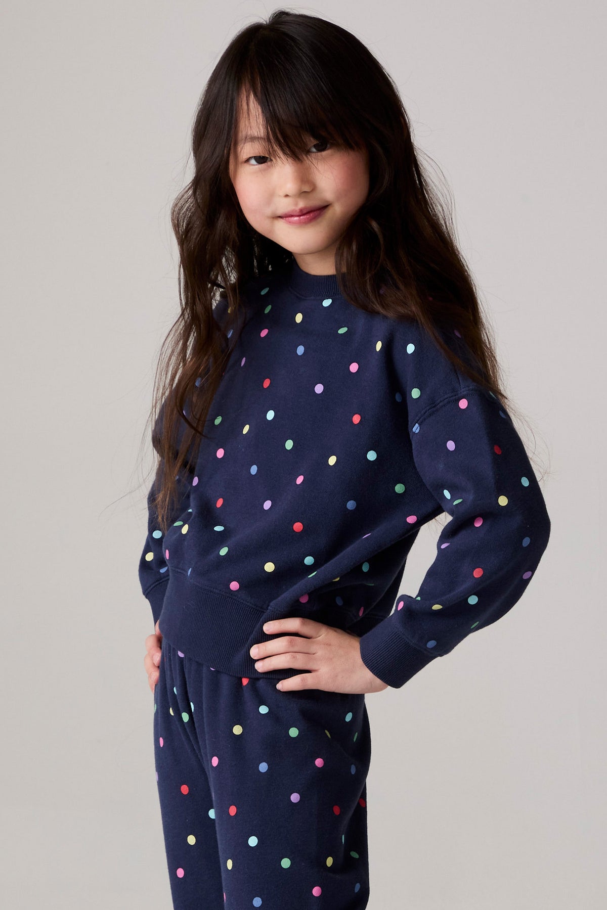 Model wearing Chaser's Festive Lights Girls Pullover in Avalon with distinctive graphic and design details, front view