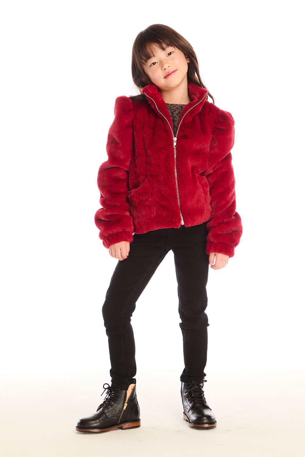 Full body view of girl wearing Chaser’s Puff Sleeve Rouge Jacket with black jeans and boots on a white background