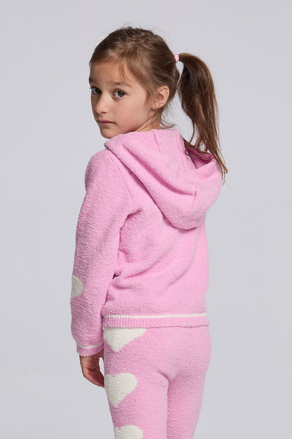 Chaser Kids Holiday Hug Girls Hoodie in pink with the hood down, rear view on a model against a light gray studio background