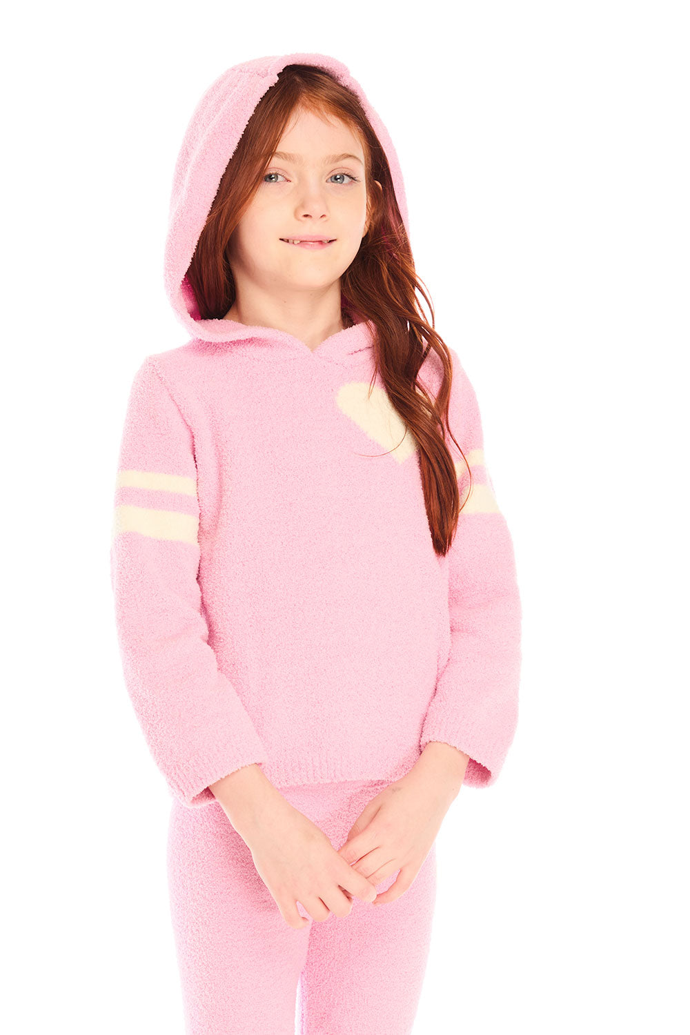 Girl wearing Chaser's Cropped Shirred Confetti Pullover pink Hoodie with hood up and matching pants on a white background