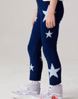 Model wearing Chaser's Allover Stars Girls Pants in lake blue with star detailing, side view