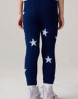 Model wearing Chaser's Allover Stars Girls Pants in lake blue with star detailing, back view