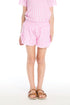 Girl wearing the Chaser Kids Pinky Gingham Grotto Shorts featuring a pink-and-white gingham pattern, ruffled hem, and drawstring waistband
