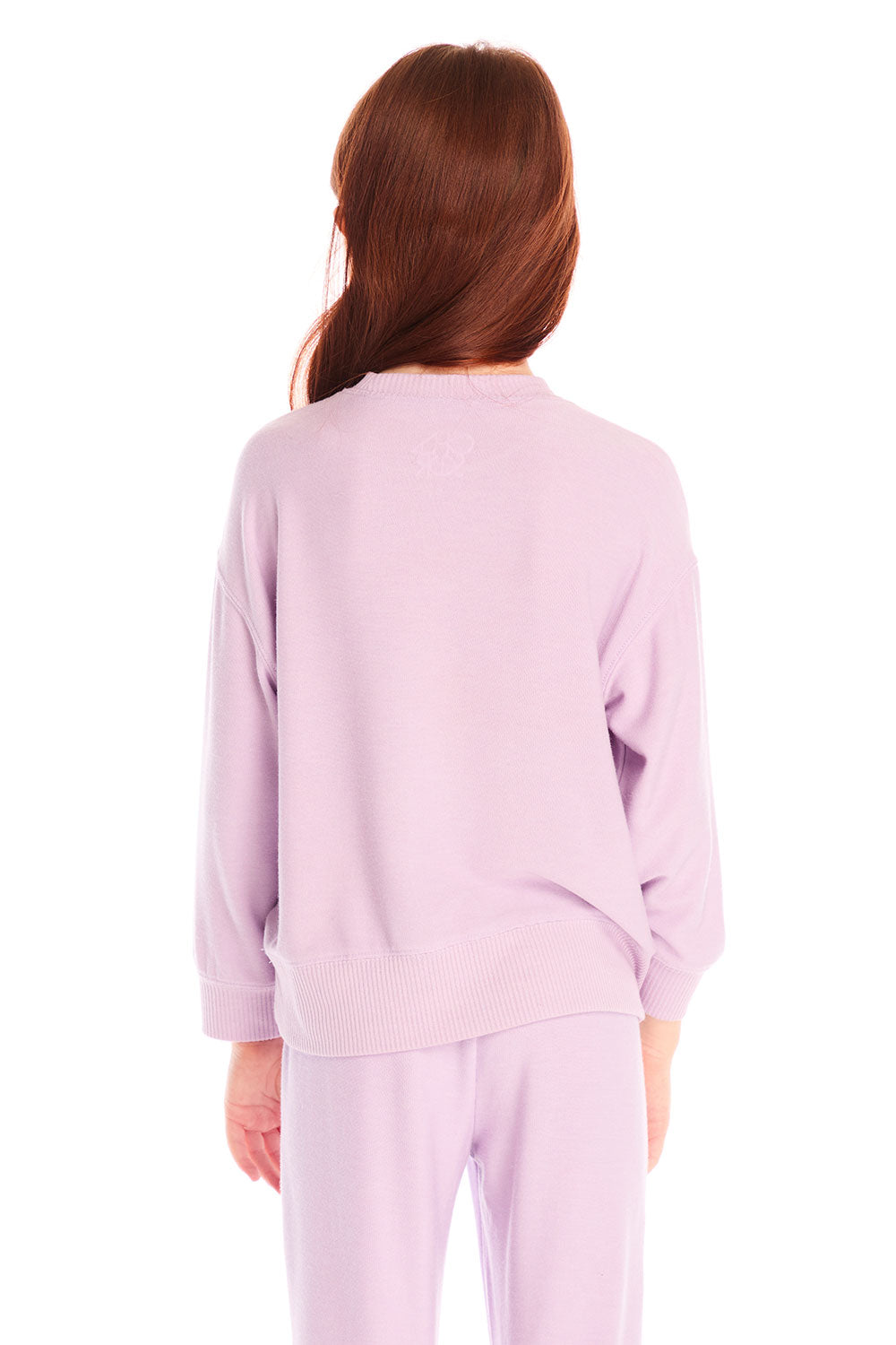 Back view of girl wearing Chaser’s pink Rainbow Glitter Heart Pullover with rainbow heart design on a white background
