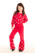 Full body view of girl wearing Chaser’s Tara Rouge Leggings with star patterns and matching Danni Rouge Pullover on a white background