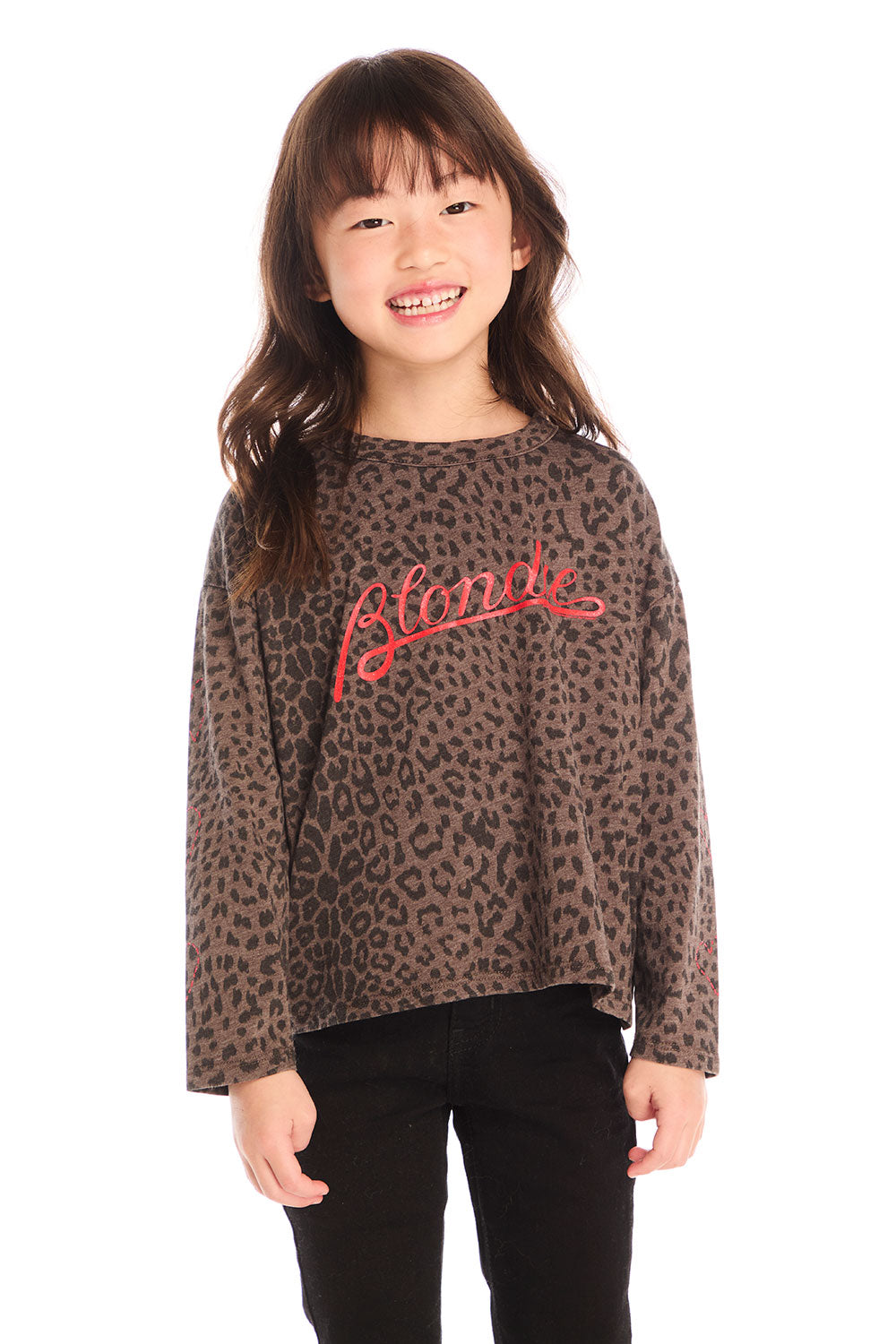 Girl wearing Chaser’s Blondie Leopard & Hearts print pullover top with red text on a white background