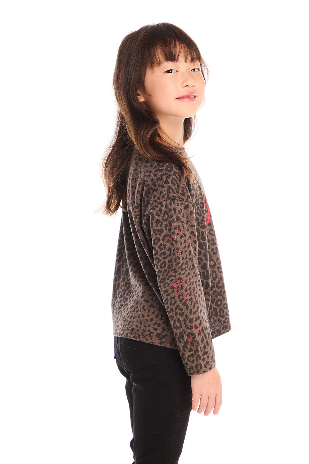 Side view of girl wearing Chaser’s Blondie Leopard & Hearts print pullover top with red text on a white background