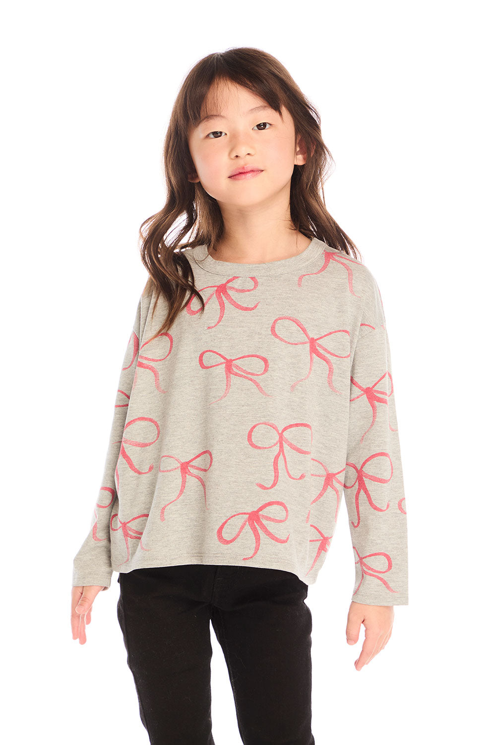 Girl wearing Chaser’s gray Red Bows Long Sleeve with pink bow pattern on a white background