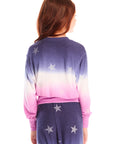 Back view of girl wearing Chaser’s Glitter Stars Ombre Tie Dye Long Sleeve with colorful star patterns and matching pants on a white background