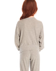 Back view of girl wearing Chaser’s Rainbow Bolts Pullover in heather grey on a white background