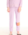 Girl wearing Chaser’s pink Rainbow Glitter Pants with rainbow heart design on a white background