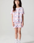 Full body front view of a girl wearing the Chaser Flutter Butterfly Tee and shorts on a neutral background