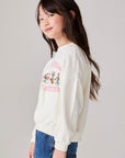 Model wearing Chaser's Grateful Dead 'Tis the Season Girls Pullover in whisper white with Grateful Dead graphic, side view
