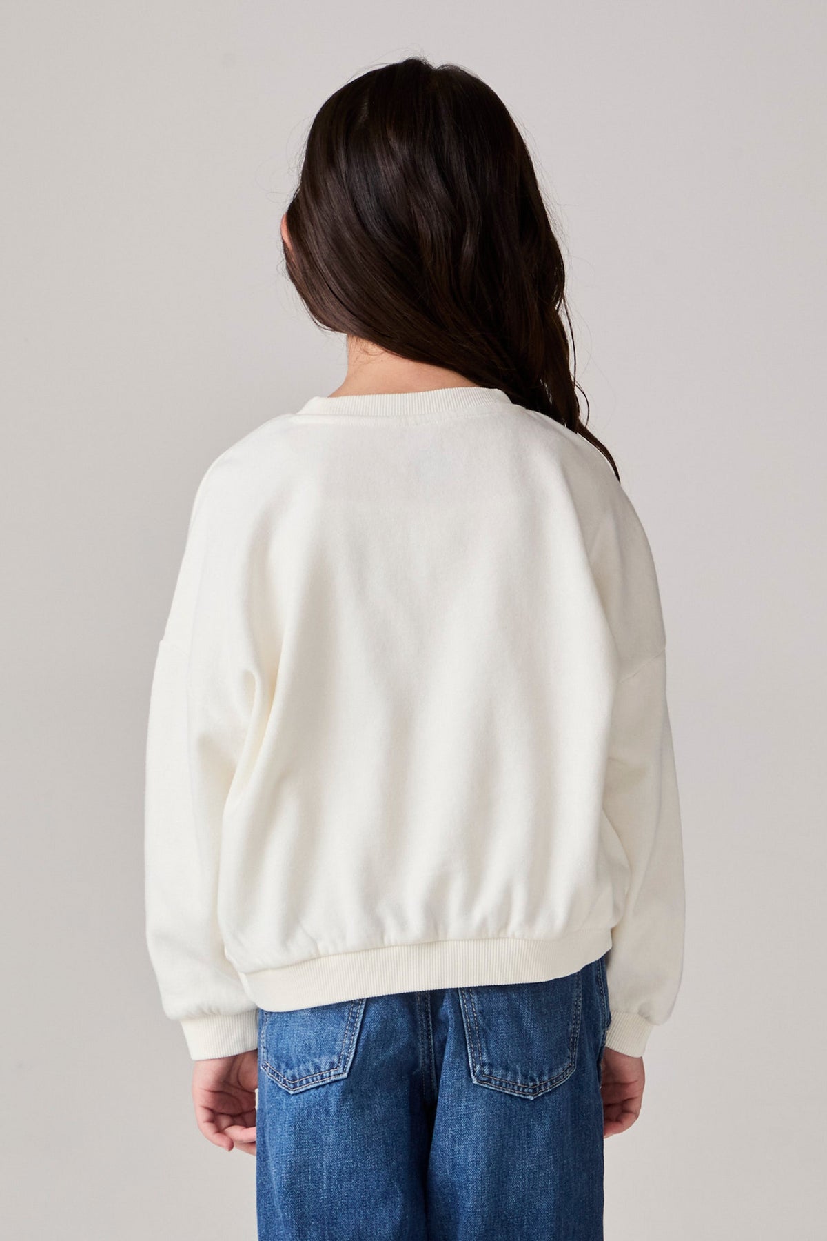 Model wearing Chaser's Grateful Dead 'Tis the Season Girls Pullover in whisper white with Grateful Dead graphic, back view