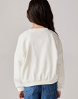 Model wearing Chaser's Grateful Dead 'Tis the Season Girls Pullover in whisper white with Grateful Dead graphic, back view