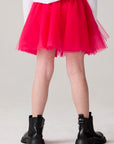 Model wearing Chaser's Holiday Ombre Girls Tulle Skort in hot bubble gum with distinctive graphic and design details, back view