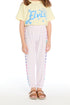 Girl wearing the Chaser Kids Love Hearts Cozy Knit Sweatpant in soft lavender with multicolor heart stripes down the legs