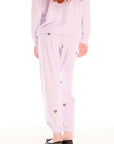 Back view of girl wearing Chaser’s pink Love Pants with heart prints on a white background