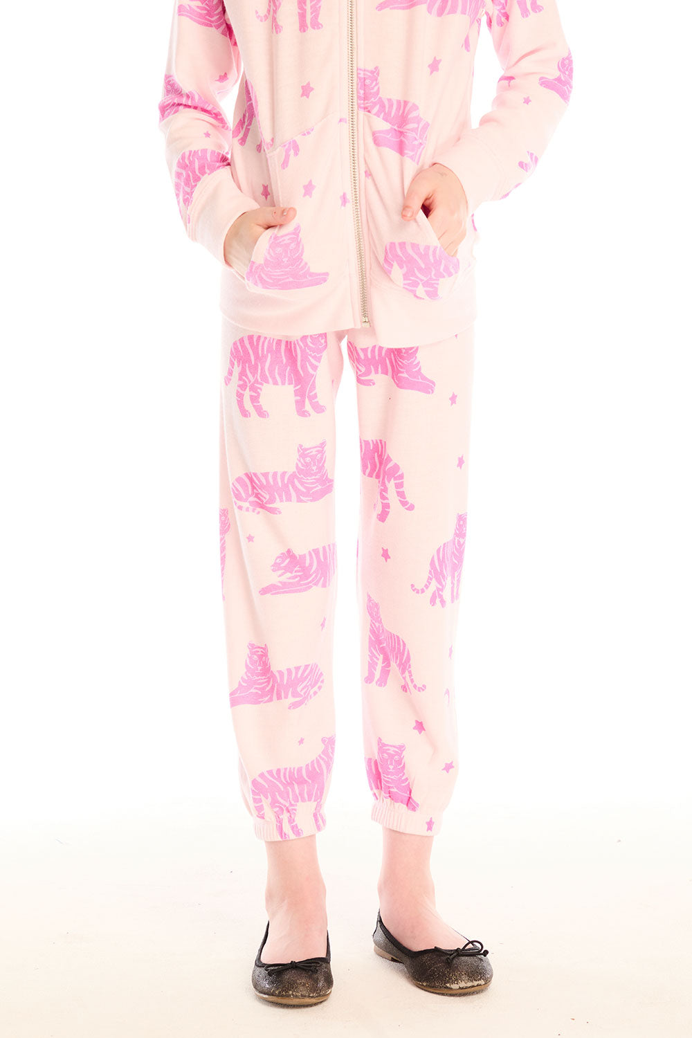 Girl wearing Chaser’s Celestial Tigers Sweatpant with pink animal pattern on a white background