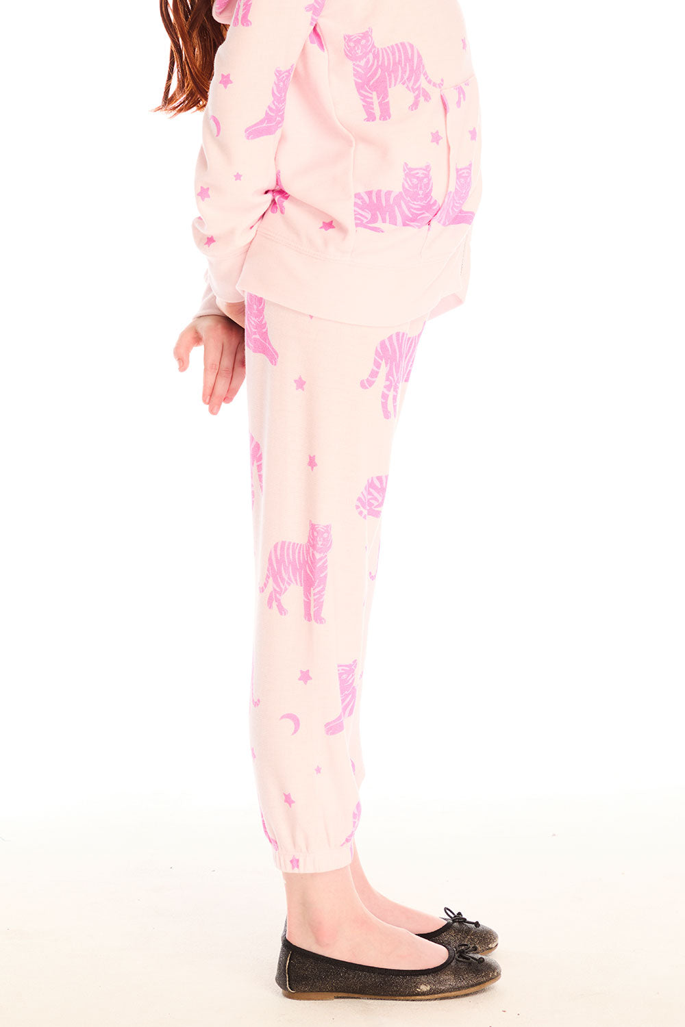Side view of girl wearing Chaser’s Celestial Tigers Sweatpant with pink animal pattern on a white background