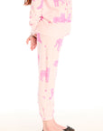 Side view of girl wearing Chaser’s Celestial Tigers Sweatpant with pink animal pattern on a white background