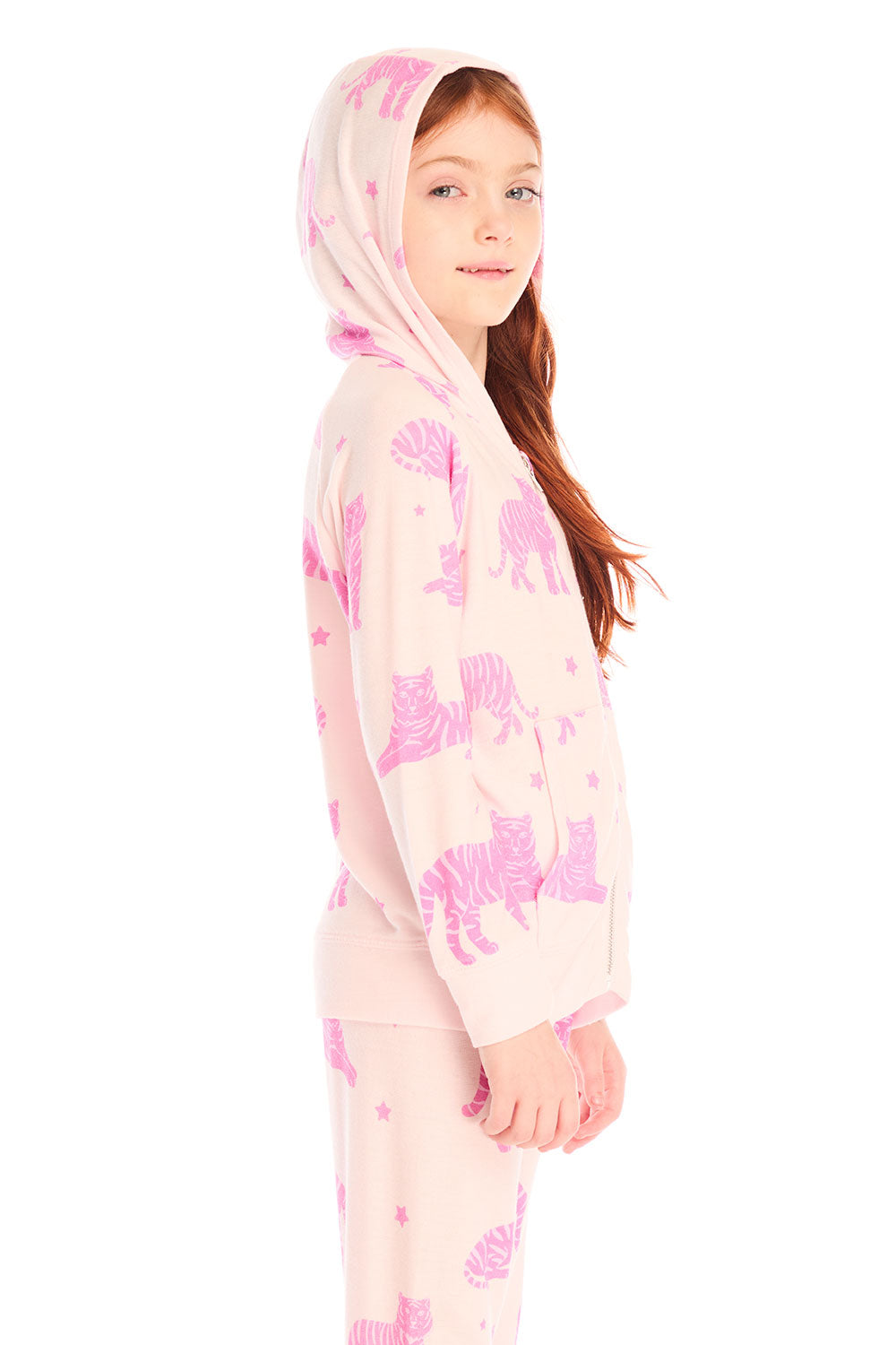 Side view of girl wearing Chaser’s Celestial Tigers Zip Up Hoodie with pink animal pattern and hood up on a white background
